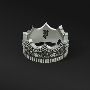sterling silver crown ring for men on a gray surface