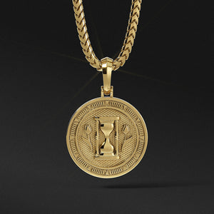 the back of a polished gold medallion for men with the hourglass and two sculpted tulips
