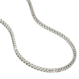 a silver franco link chain lying on a white surface