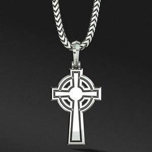 the back of a cross pendant shows a shining flat surface with simple engravings
