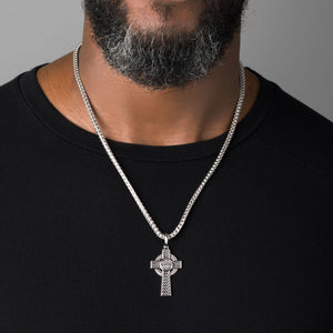man wears a large celtic silver cross necklace men's chain