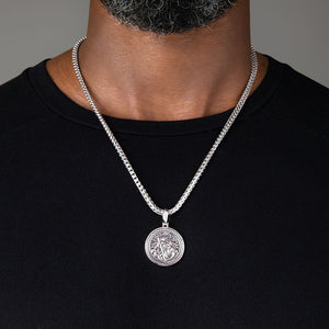 Large round Saint Christopher necklace for men, being worn by a man in a black shirt