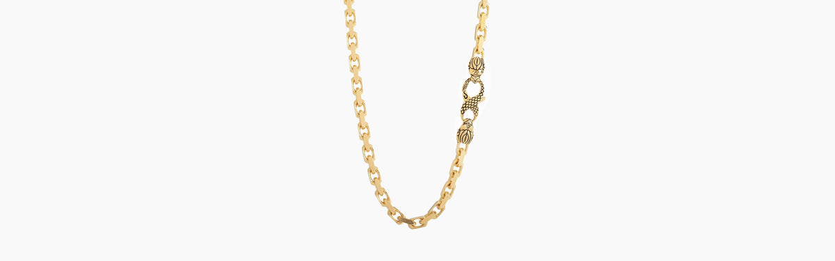 Gold Franco, Cuban and link chains laid side by side on a black mat