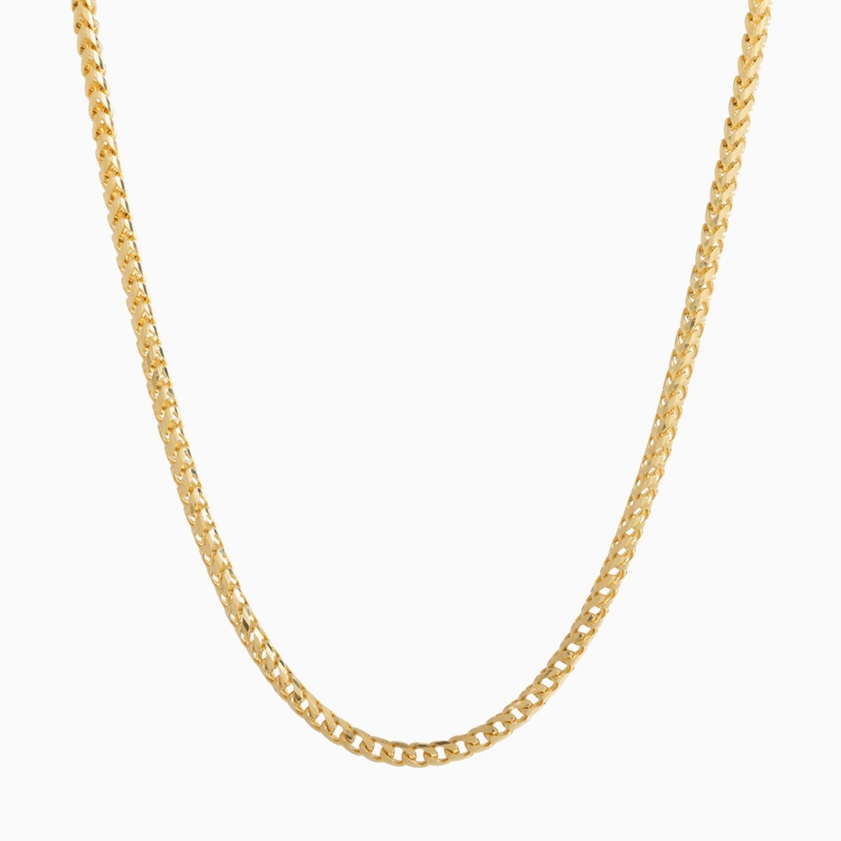 An 18 karat yellow gold diamond cut franco chain hangs in a white setting