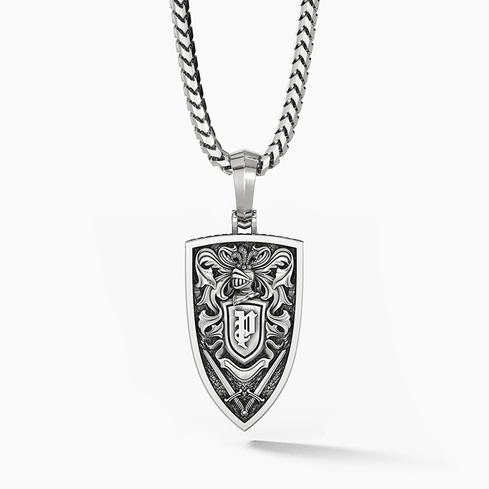 The back of a silver lion pendant features a royal pattern and swords