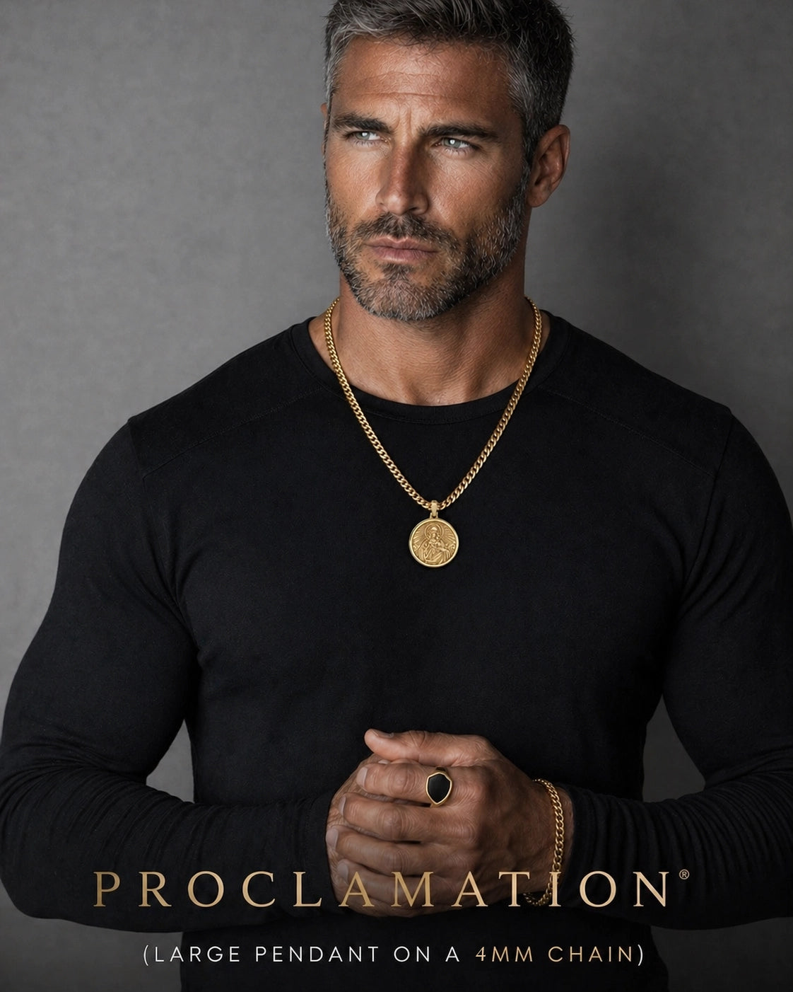 Man wearing a large Gold Sacred Heart of Jesus Pendant on gold chain on a gray background