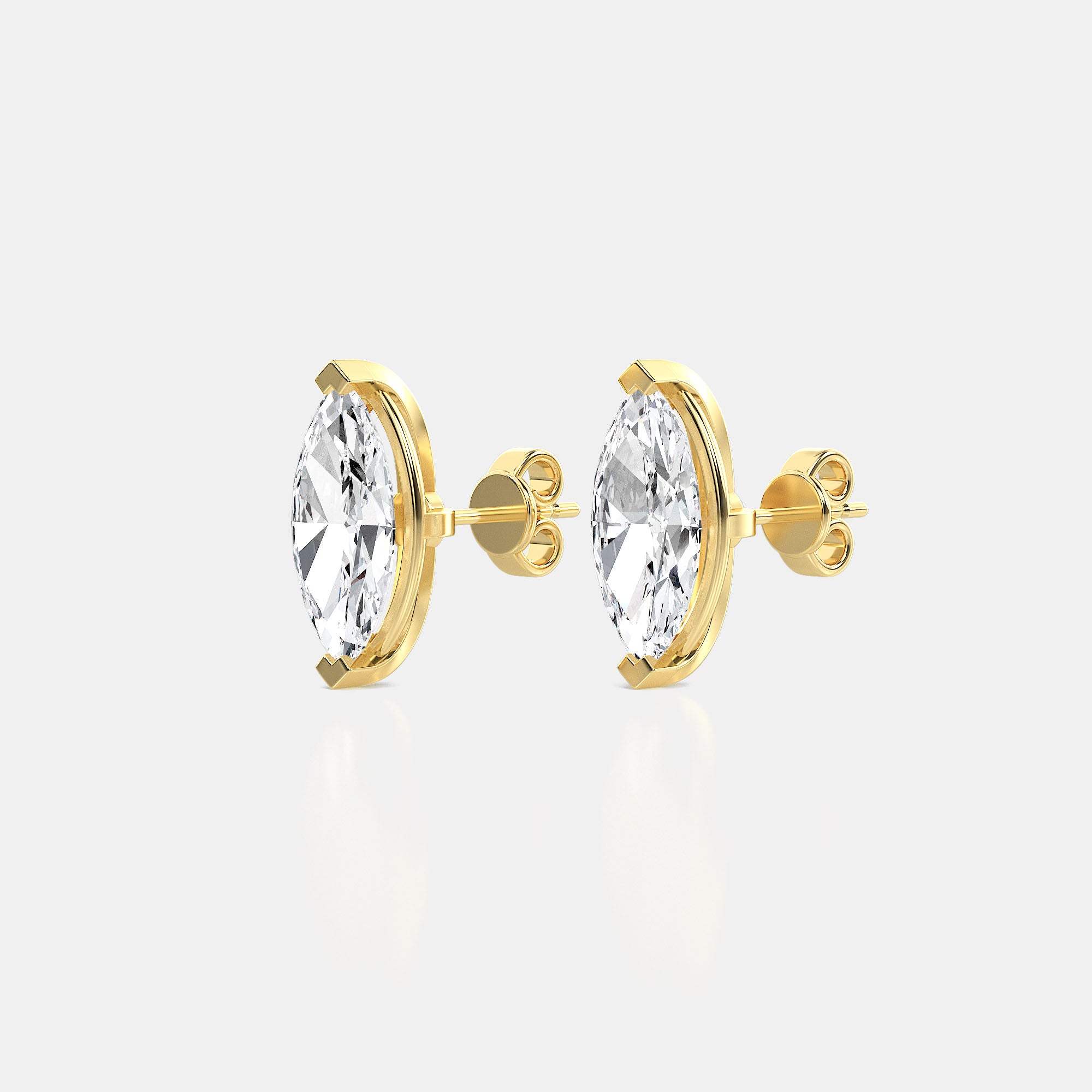 Gold earrings with diamonds on a light gray background