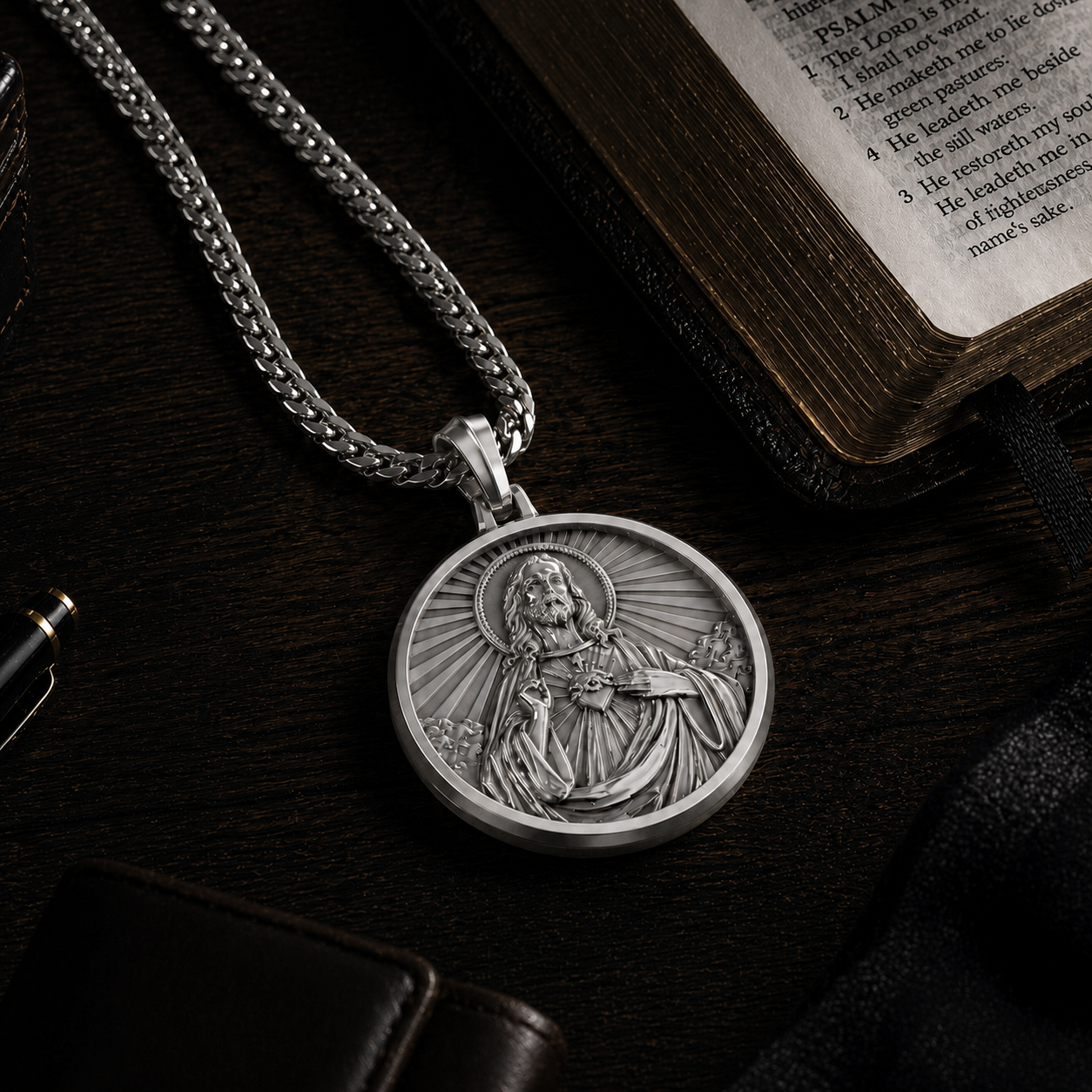 Silver pendant necklace with religious design on an open book
