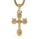 A gold cross pendant necklace featuring lion heads at the center and corners, each adorned with a small crown and accented with clear rhinestones and red gemstone eyes, suspended from a gold chain on a white background.