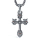 A silver-toned metal cross pendant necklace featuring lion heads with red eyes at the corners and center, suspended from a matching chain on a white background.