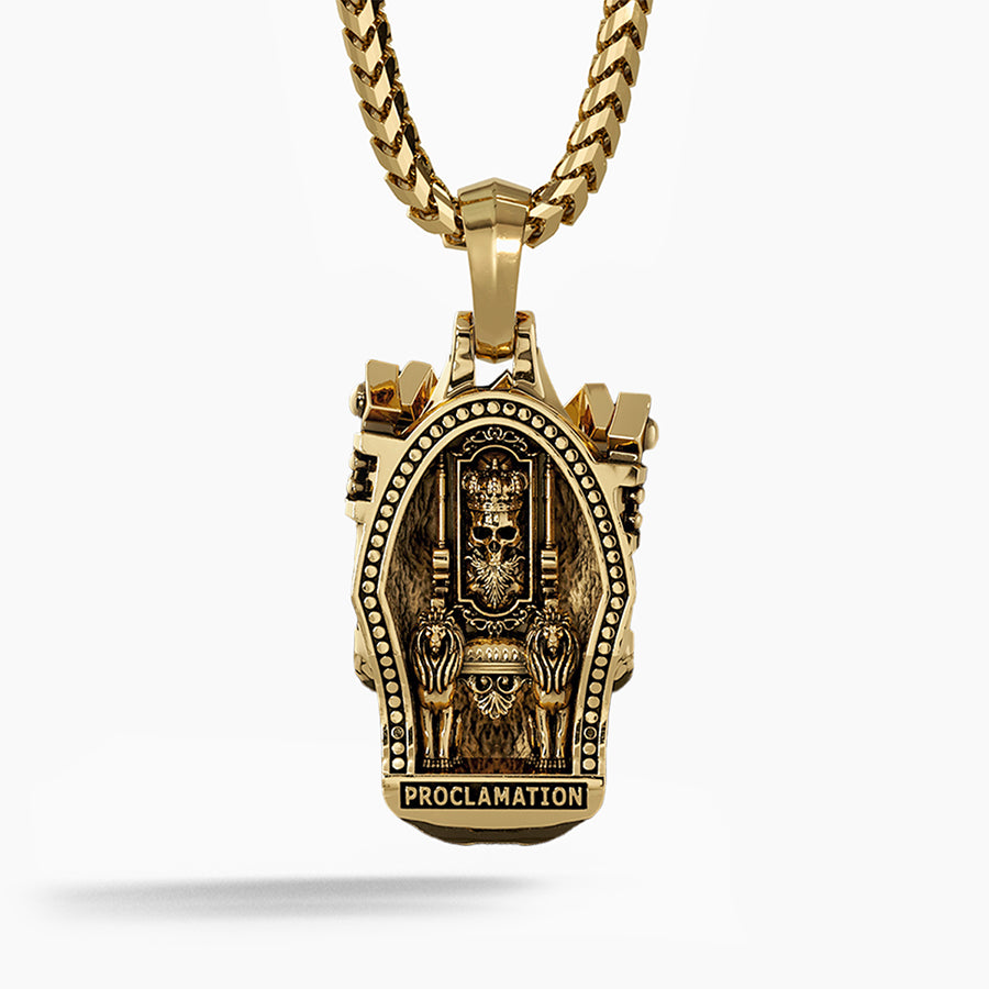 The back of a gold skull pendant shows a throne carved into the metal