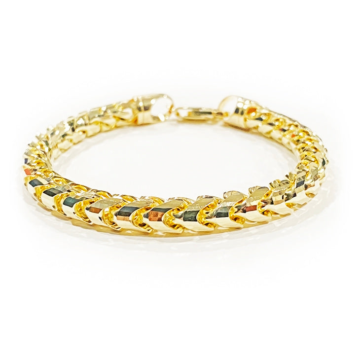 facets gleam in this closeup image of a 14 karat yellow gold 7mm diamond cut franco bracelet