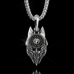 white gold wolf pendant showing a dreamcatcher on the back