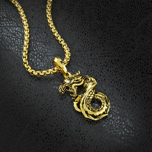 a roaring gold dragon pendant shines on a black leather surface