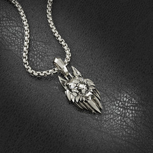 A white gold wolf pendant lies on leather