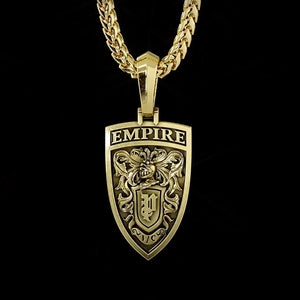 The back of a gold lion pendant features a crest with a knight's helmet and swords