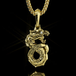 the back side of a gold and diamond dragon pendant says Proclamation