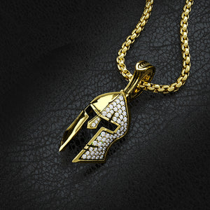 a solid gold Spartan pendant with diamonds pave'd on half of the helmet lays on a black leather surface