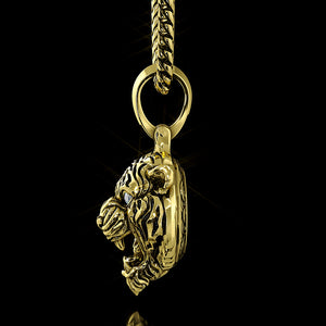 the side profile of a three dimensional gold tiger pendant