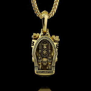 The back of a gold skull pendant shows a throne carved into the metal