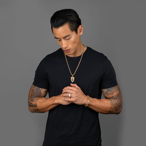 a man in a black shirt with tattoos wearing a 5mm prism cut franco chain and diamond lion pendant