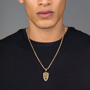 a man in a black shirt wears a polished gold lion pendant with diamonds