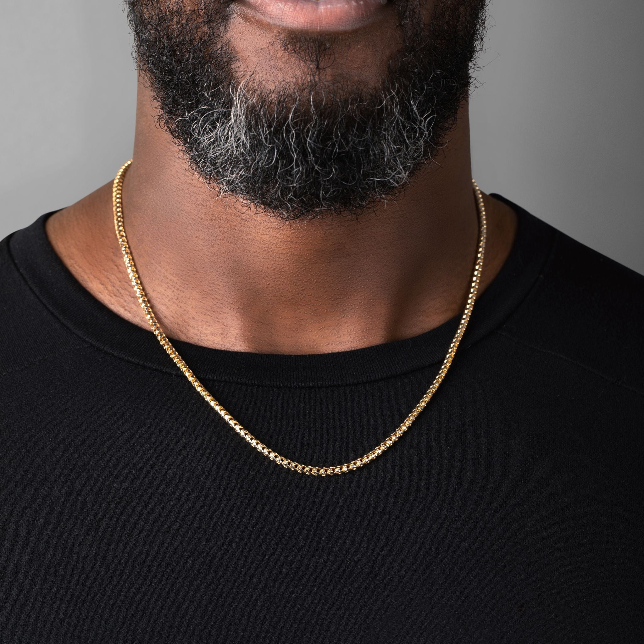 man in a black shirt wearing a 3mm prism cut franco chain