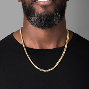 a man in a black shirt wearing a 5mm diamond cut franco gold necklace for men