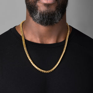 a man in a black shirt wearing a 7mm diamond cut franco gold necklace for men