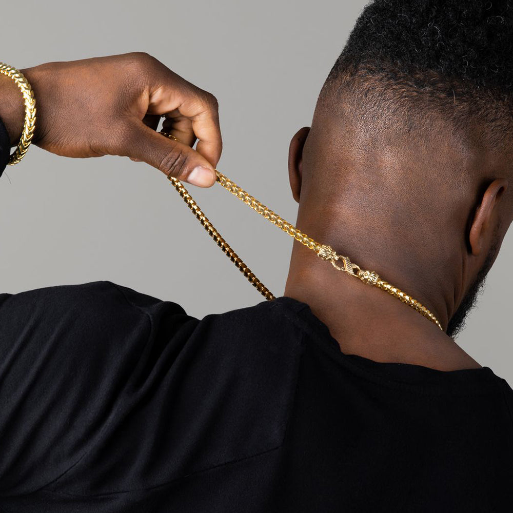 the man is wearing a 7mm gold franco chain and showing the custom lion and snake clasp on his neck