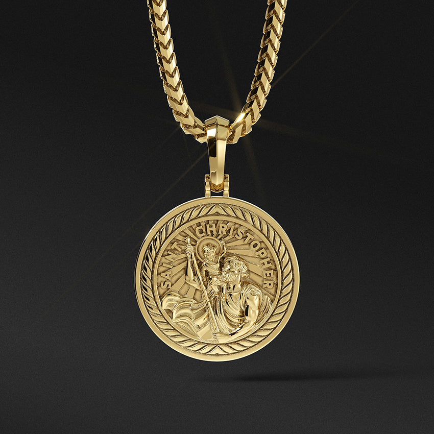 a round and polished gold Saint Christopher pendant with the sculpted saint carrying baby Jesus