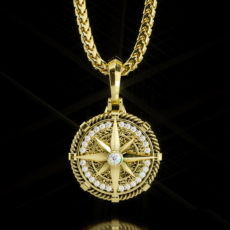 a detailed gold compass pendant with diamonds hangs from a silver chain