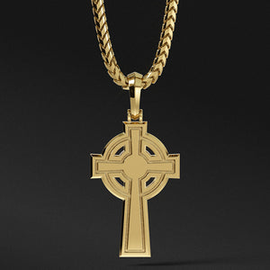 the back of a Celtic cross pendant shows a shining flat surface with simple engravings