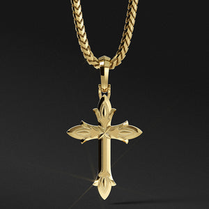 a mens gold cross necklace hangs from a 14 karat chain