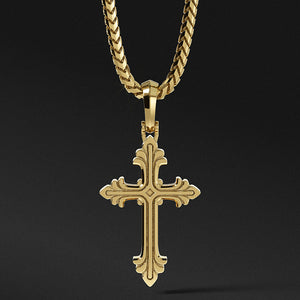 a mens gold cross necklace hangs from a chain