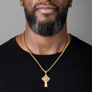 man wears a gold Celtic cross necklace and franco chain