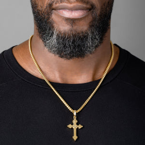 man wears a gold cross necklace and franco chain