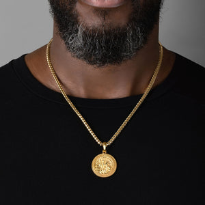 Large round Saint Christopher necklace for men, being worn by a man in a black shirt