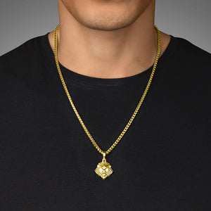 a man in a black shirt wears a polished gold lion pendant