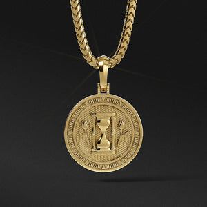 the back of a polished gold medallion for men with the hourglass and two sculpted tulips