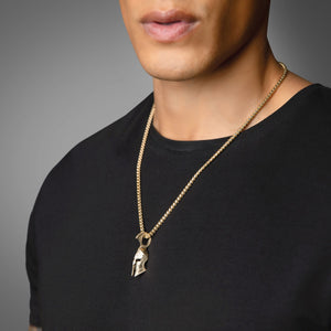 a man in a black shirt wearing a gold Spartan pendant hanging from a 3mm franco chain