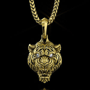 a gold tiger pendant with diamond eyes hangs on a gold chain