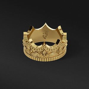 a gold crown ring with fleur-de-lis designs