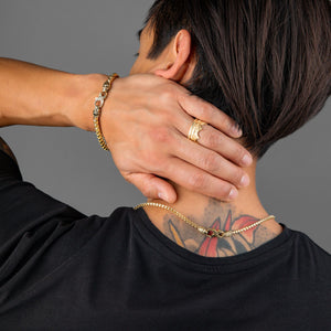 a gold crown wedding band is featured in a set of mens gold jewelry