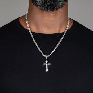 man wears a large sculpted silver cross necklace men's chain