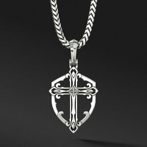 a sterling silver cross necklace in the shape of a shield hangs from a chain