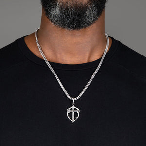 man wears a large silver cross necklace men's chain