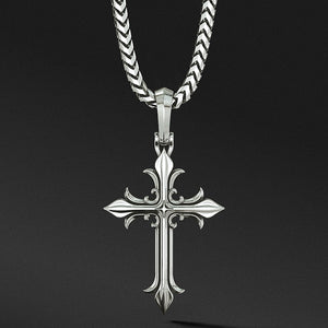a unique sterling silver cross necklace hangs from a chain