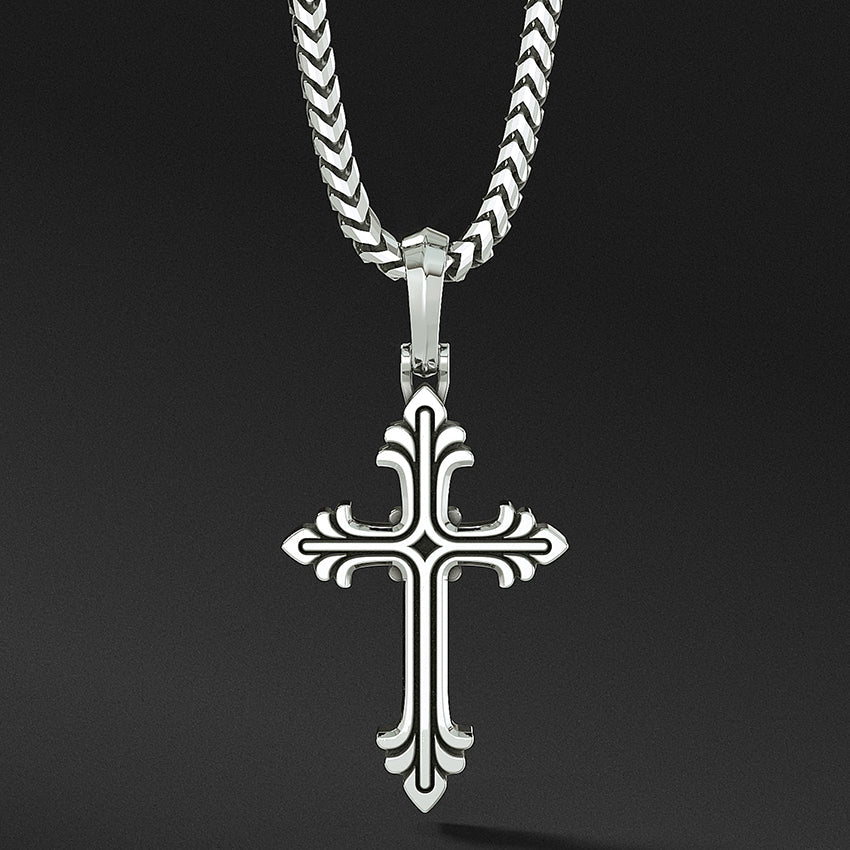 a sterling silver cross necklace hangs from a chain