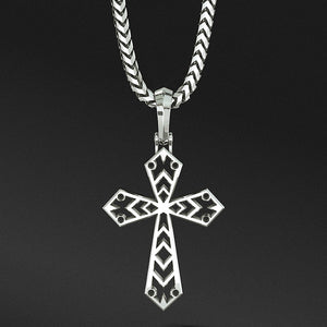 a sterling silver cross necklace hangs from a chain